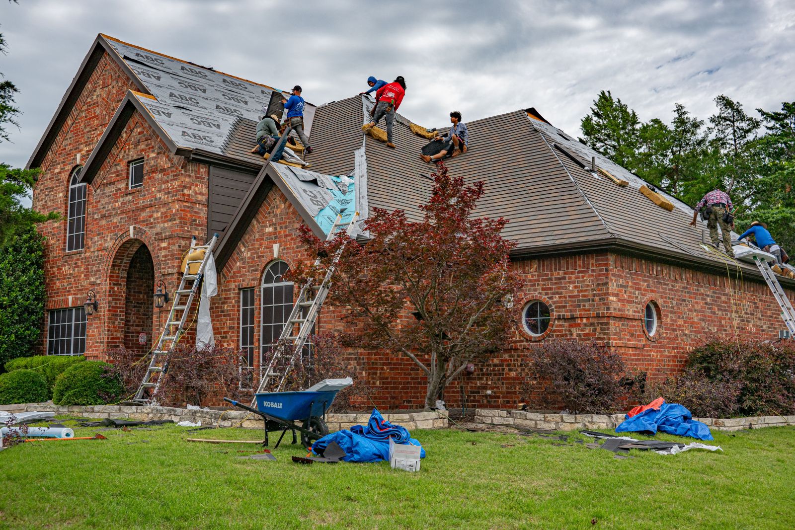 Roofing crew completing an asphalt shingle roof replacement in Bristol