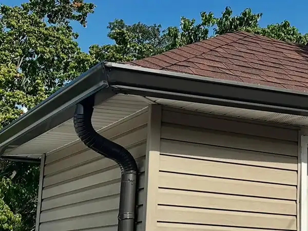 New black gutters installed on home